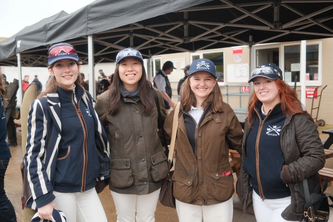 Four members in OUCPSC caps and club fleeces at a competition